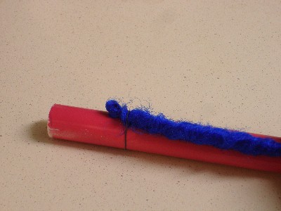 Image: Dread fastened to a dowel with a rubber band