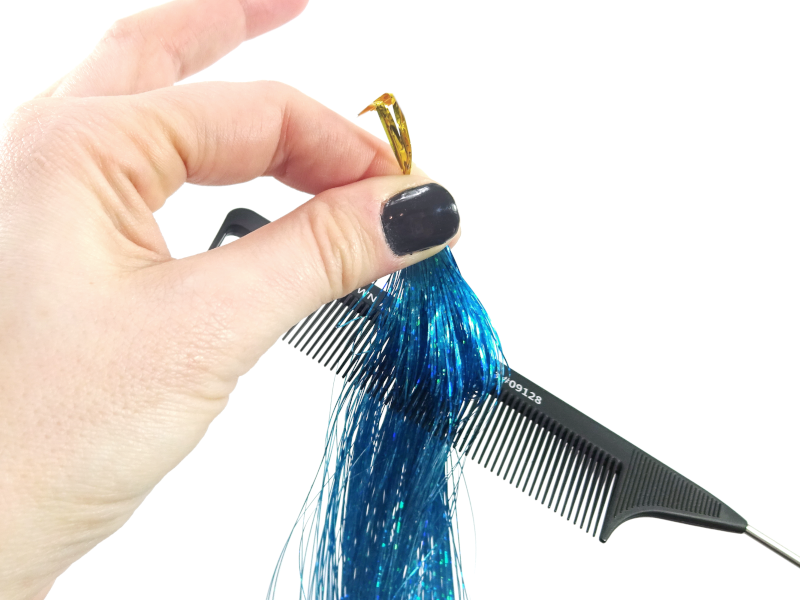Pinching the top of the tinsel before dealing with any tangles helps keep it in place.